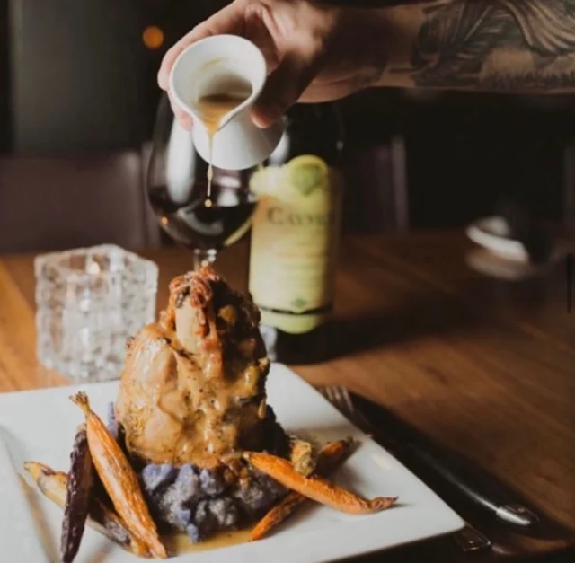 🎶🍷There’s nothing like a cozy evening slopeside with friends and a glass of Cabernet Sauvignon to warm you up. Indulge in our slow-cooked pork shank at Vail Chophouse – tender, flavorful comfort food that hits all the right notes. 
Perfect for unwinding after a day on the slopes. 🍷 #VailChophouse #ComfortFood #SlowCookedPorkShank #SlopesideVibes #CabernetSauvignon #CozyEvenings